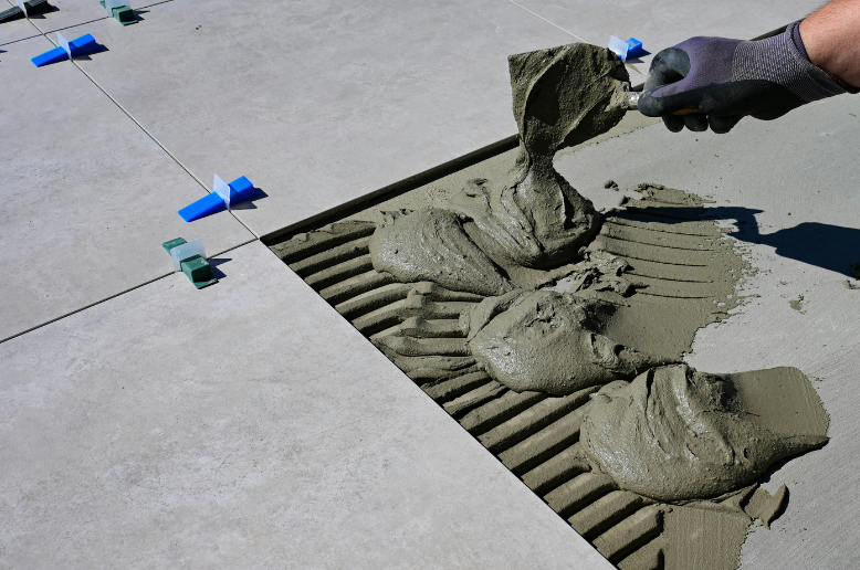 employee laying floor tiles
